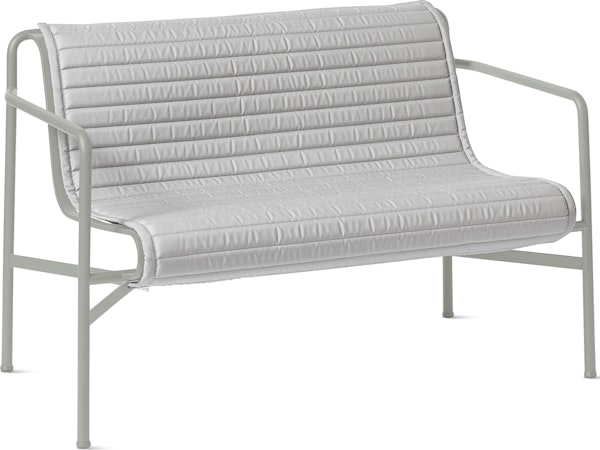 A three quarter view of a Palissade Dining Bench Quilted Cushion in light grey.